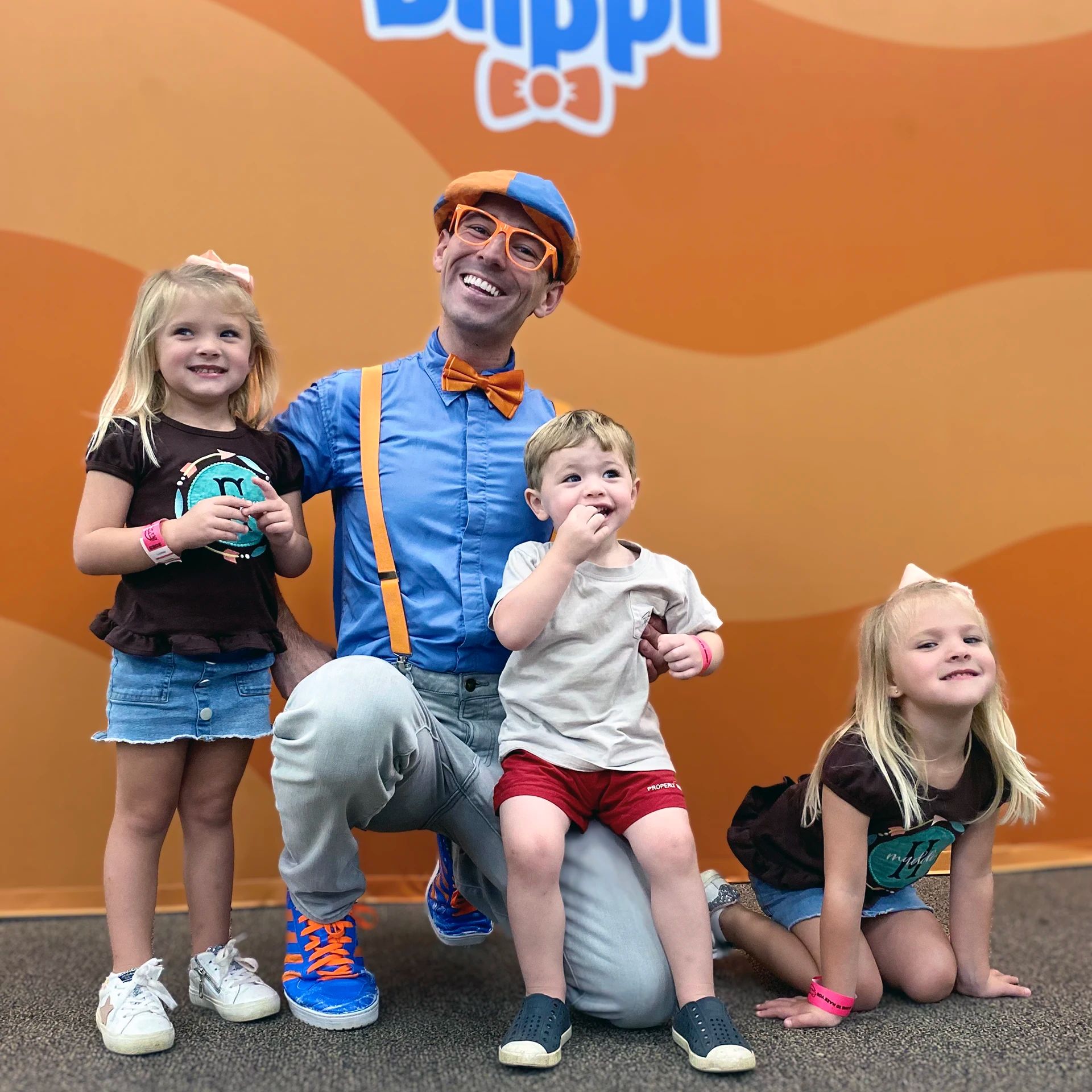 Fans pose with Blippi for a photo.